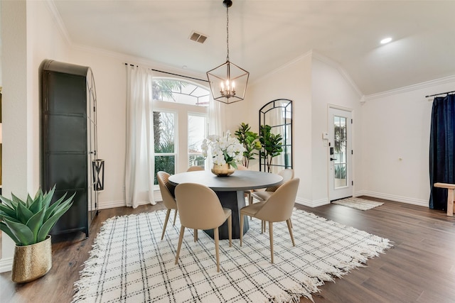 dining room featuring lofted ceiling, dark wood-type flooring, visible vents, and crown molding