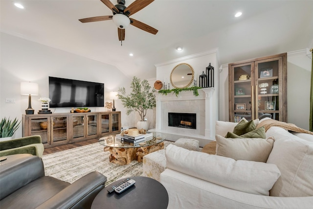 living area with a fireplace, recessed lighting, lofted ceiling, ceiling fan, and wood finished floors