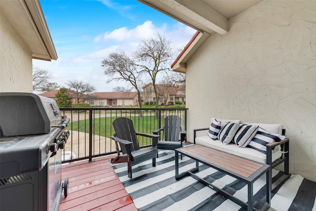 wooden terrace with a grill, an outdoor hangout area, and a yard