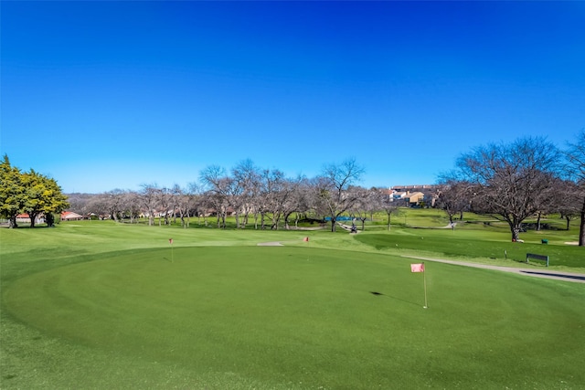 view of community featuring a yard and golf course view