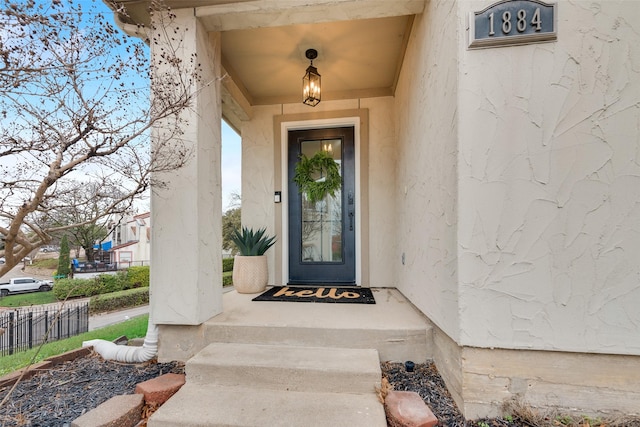 view of exterior entry with fence