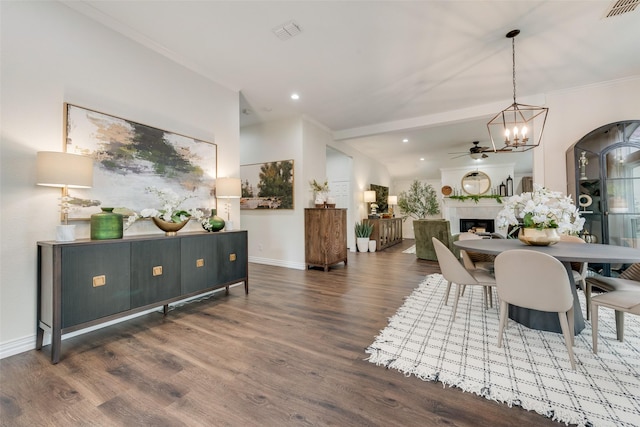 dining area with baseboards, a fireplace, visible vents, and wood finished floors