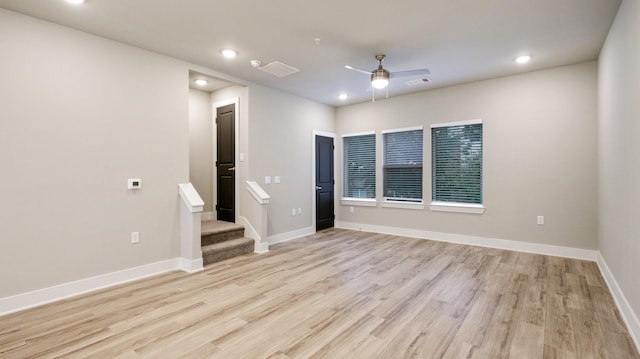 empty room with visible vents, a ceiling fan, stairs, light wood-type flooring, and recessed lighting