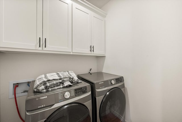 laundry area with cabinet space and separate washer and dryer