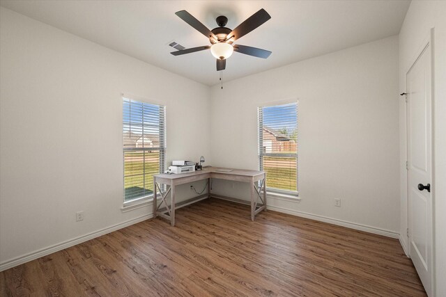 2301 Camryn Ln, Mabank, TX 75147 - unfurnished bedroom with wood finished floors, multiple windows, and baseboards