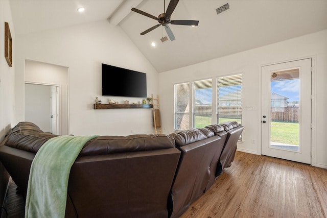 living area with visible vents, ceiling fan, wood finished floors, high vaulted ceiling, and beam ceiling