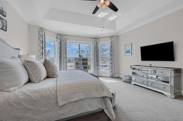 bedroom featuring baseboards, a raised ceiling, carpet floors, and ceiling fan