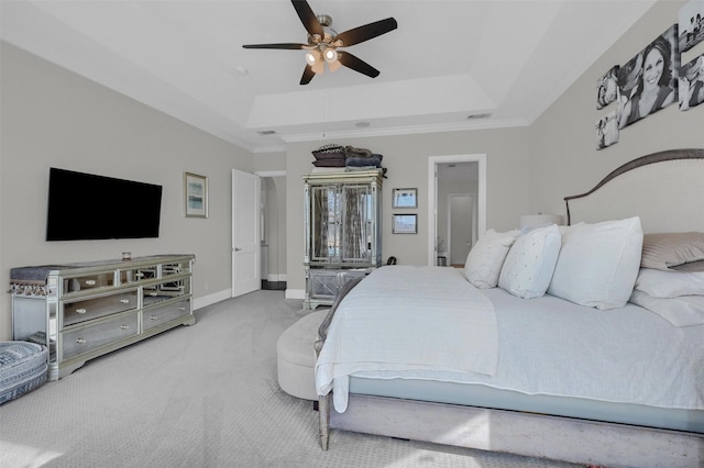 bedroom featuring baseboards, carpet, a tray ceiling, and a ceiling fan