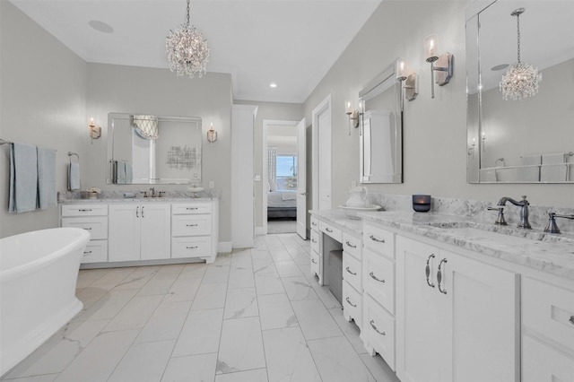 full bathroom with a sink, marble finish floor, a freestanding bath, and two vanities