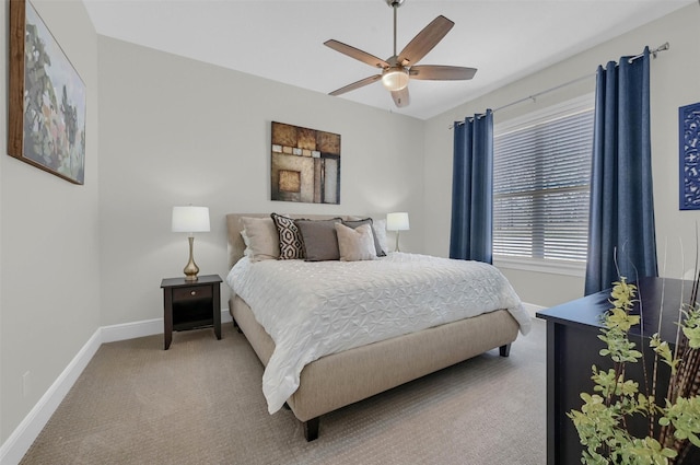 bedroom featuring light carpet, a ceiling fan, and baseboards