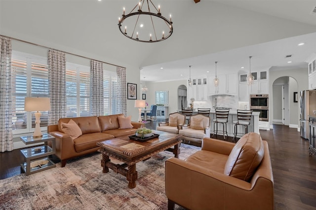 living room featuring recessed lighting, arched walkways, high vaulted ceiling, and dark wood-style flooring