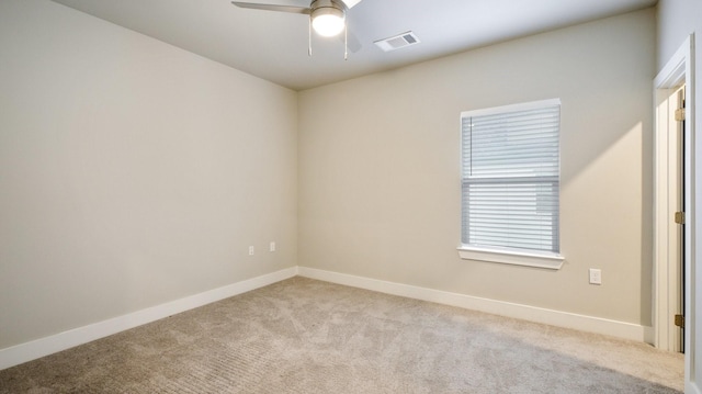 unfurnished room with carpet floors, baseboards, visible vents, and ceiling fan