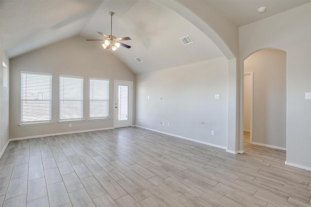unfurnished living room with visible vents, arched walkways, lofted ceiling, ceiling fan, and light wood-style flooring