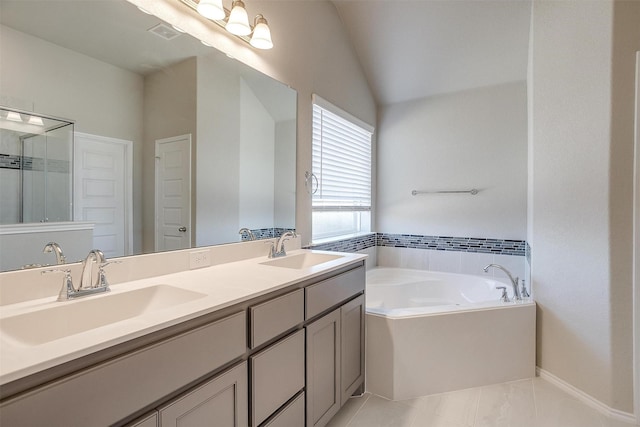 bathroom featuring double vanity, visible vents, a sink, and a bath