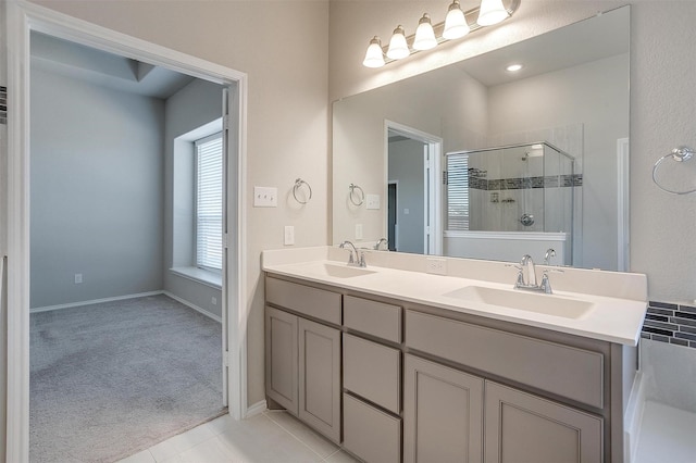 full bathroom with tile patterned floors, a sink, a shower stall, and double vanity