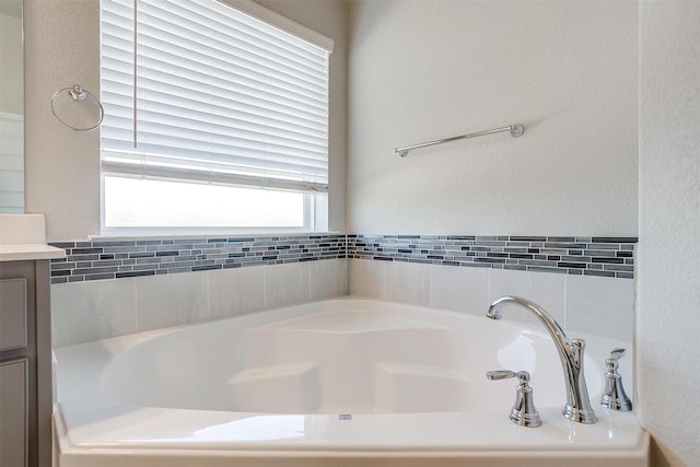 bathroom with a bath and vanity
