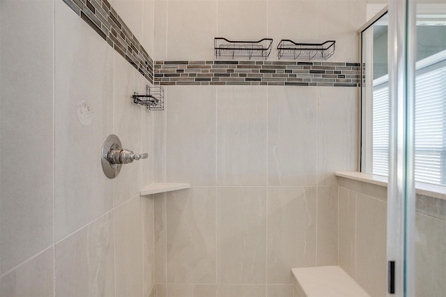 bathroom with tiled shower