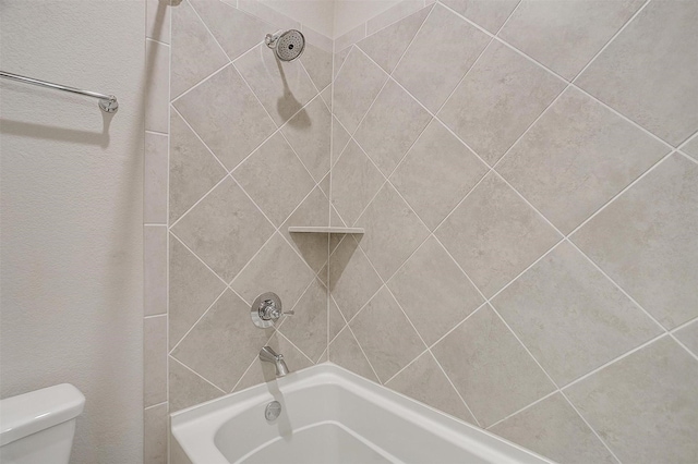 bathroom with tub / shower combination and toilet