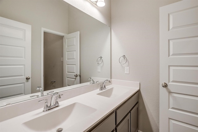 bathroom with a sink and double vanity