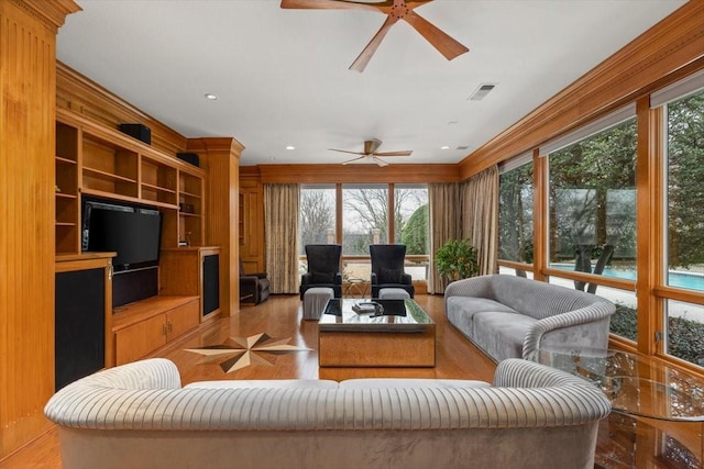 living area with a ceiling fan, recessed lighting, visible vents, and built in shelves