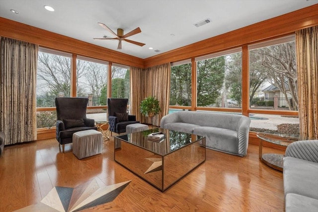 sunroom featuring ceiling fan and visible vents