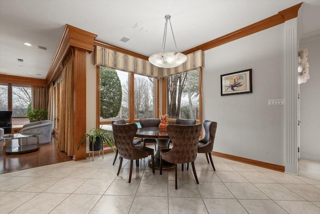 dining room featuring light tile patterned floors, ornamental molding, and baseboards