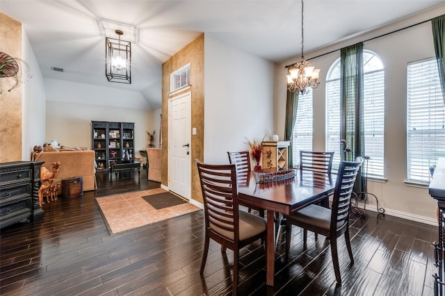 dining room featuring a wealth of natural light, baseboards, a chandelier, and dark wood-style flooring