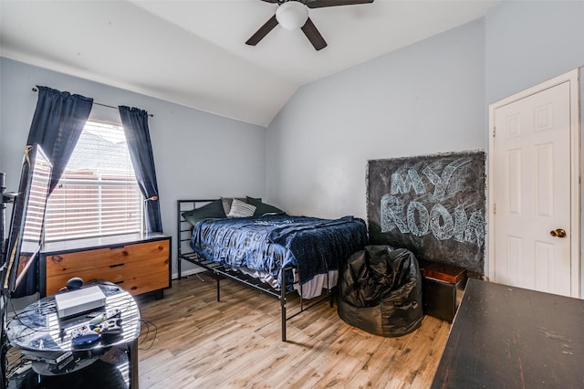 bedroom featuring ceiling fan, vaulted ceiling, and wood finished floors