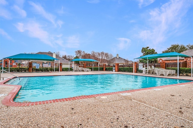 pool featuring fence and a patio