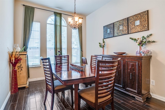 dining room with dark wood-type flooring, a chandelier, plenty of natural light, and baseboards