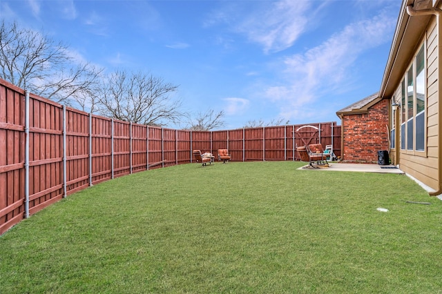 view of yard featuring a patio area and a fenced backyard
