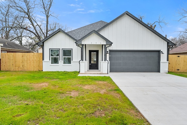 modern farmhouse style home with concrete driveway, fence, board and batten siding, and roof with shingles