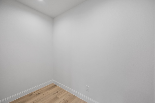 spare room with light wood-style flooring and baseboards