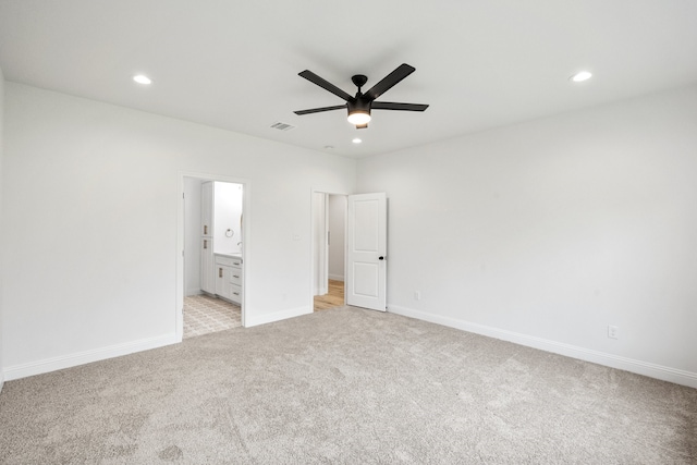 unfurnished bedroom featuring light colored carpet, visible vents, baseboards, and recessed lighting