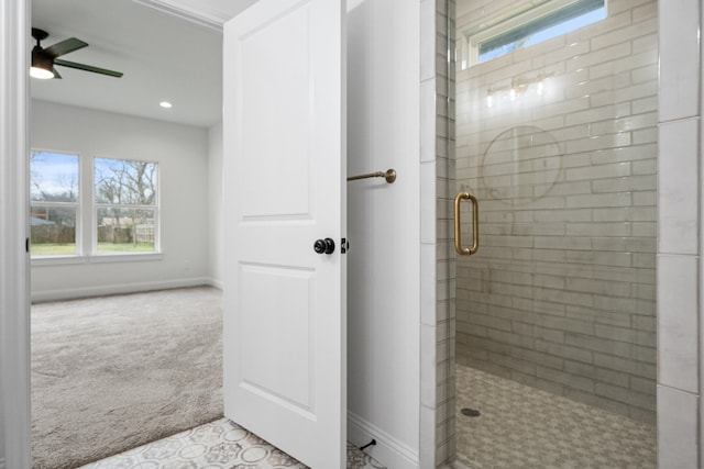 full bath with ceiling fan, a shower stall, and baseboards