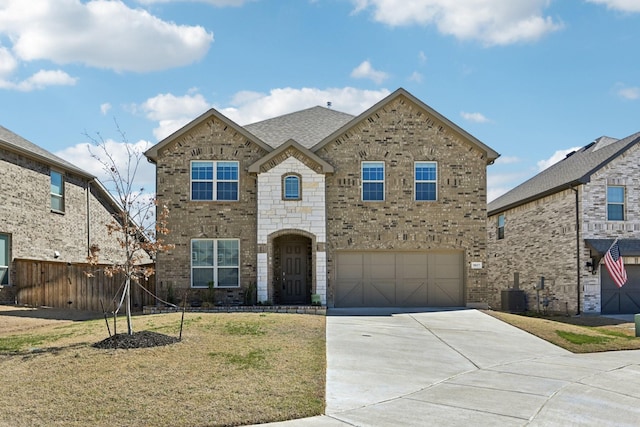 view of front of property with brick siding, fence, concrete driveway, and a front yard