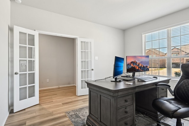 office with french doors, light wood-style flooring, and baseboards