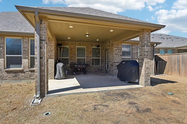 9017 Cattle Herd Dr, Fort Worth, TX 76123 - rear view of property featuring a patio, brick siding, and roof with shingles
