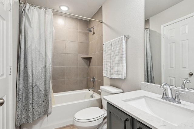 bathroom featuring toilet, shower / bathtub combination with curtain, and vanity