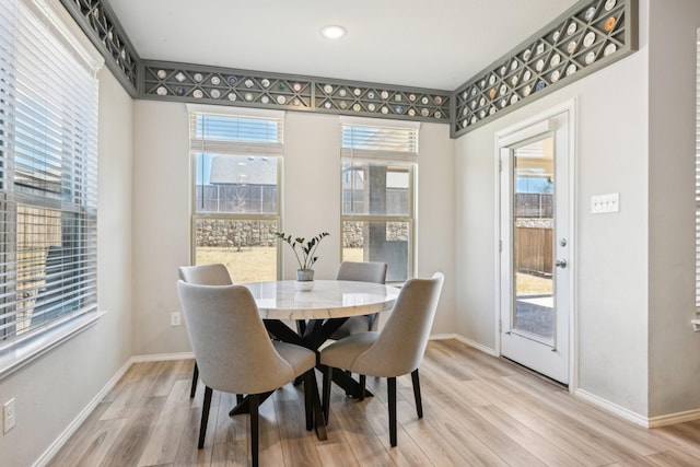 dining area featuring light wood-style floors and baseboards