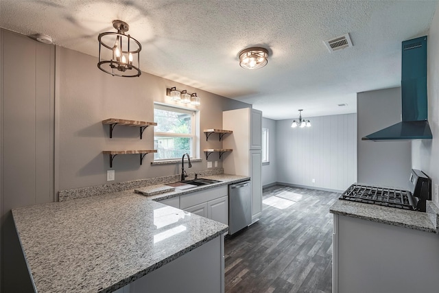 kitchen featuring open shelves, visible vents, a sink, wall chimney range hood, and dishwasher