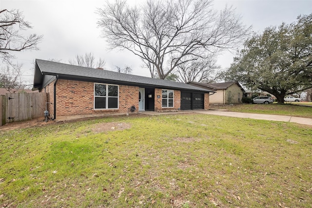 single story home with brick siding, an attached garage, a front yard, fence, and driveway