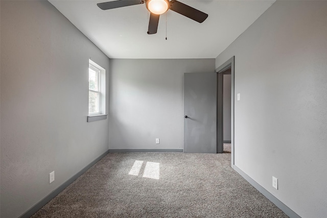 carpeted spare room with baseboards