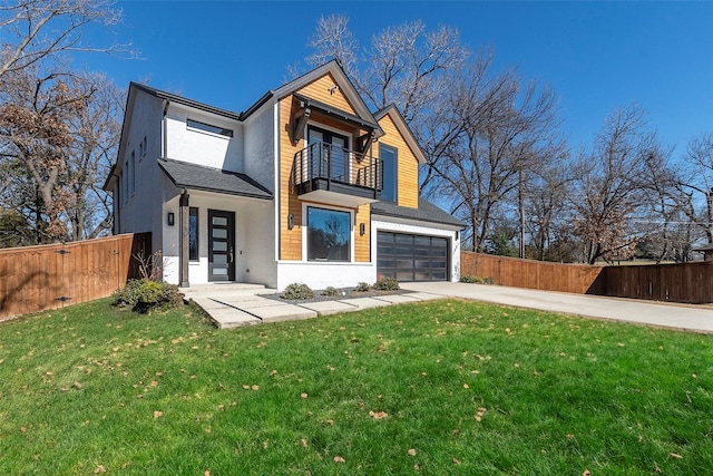 contemporary home featuring concrete driveway, fence, and a balcony