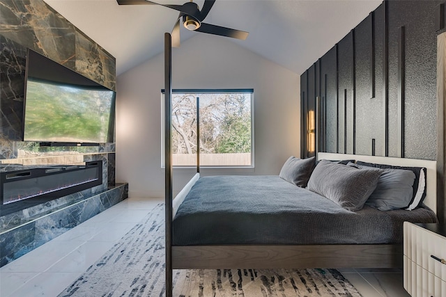 bedroom featuring vaulted ceiling, marble finish floor, a premium fireplace, and ceiling fan