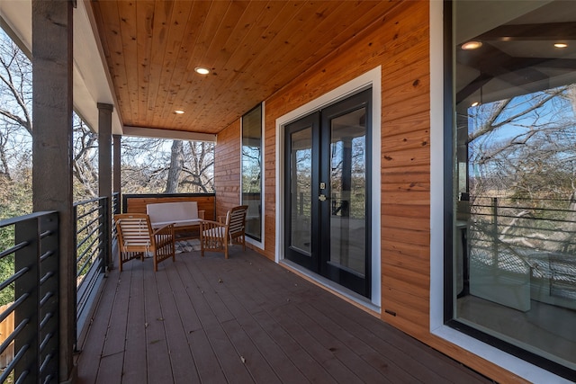 wooden deck featuring french doors and outdoor lounge area