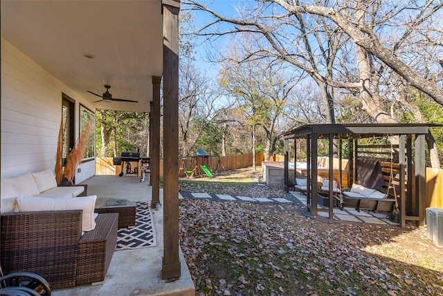 exterior space featuring a patio, a ceiling fan, a fenced backyard, a jacuzzi, and an outdoor living space