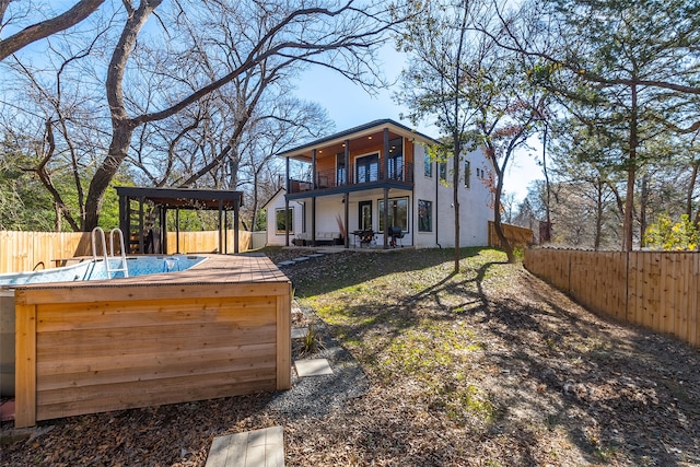 exterior space featuring a fenced backyard and a balcony