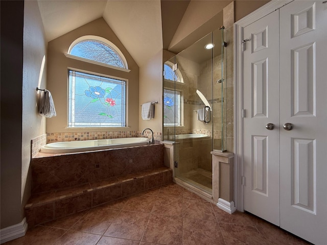 full bath with lofted ceiling, tile patterned flooring, a shower stall, and a bath