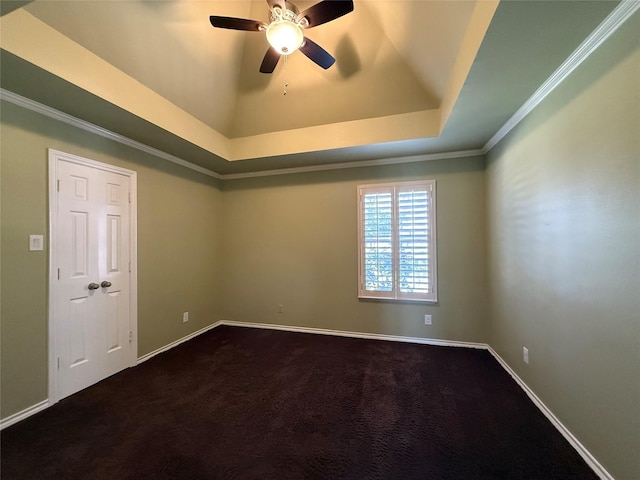 unfurnished room with dark colored carpet, crown molding, and baseboards